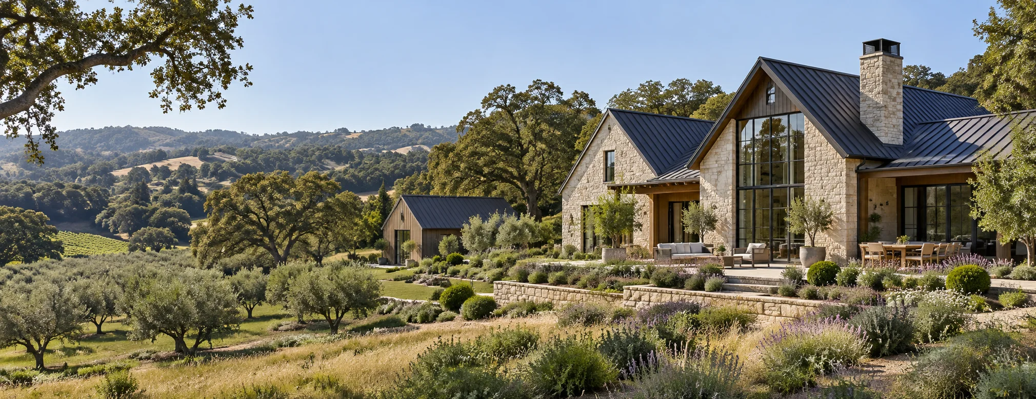 Stone estate home with a barn and olive grove on rolling oak-covered acreage